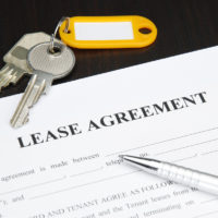 Lease agreement document with keys and pen