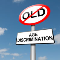 Age discrimination road sign and no old people allowed sign with blue sky background