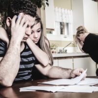 men with financial stress at home